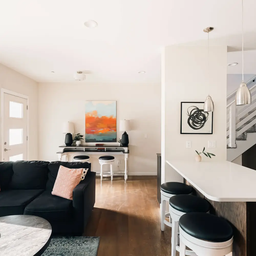 Living area, entry, and open kitchen with island