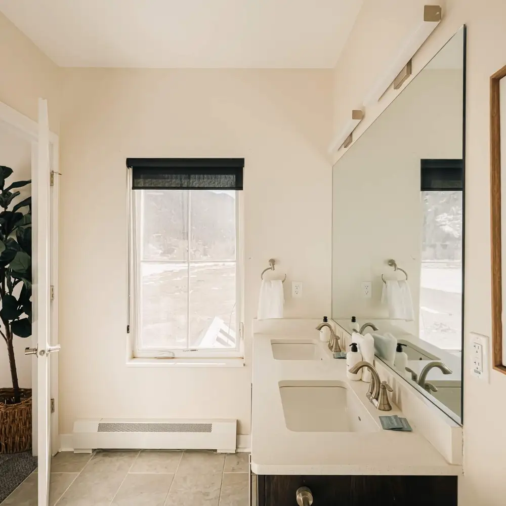 Full private ensuite bathroom with dual vanities
