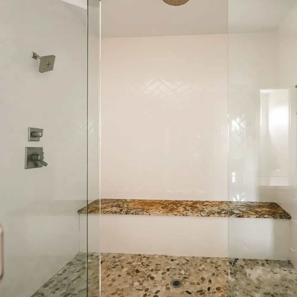 En suite bathroom has dual shower heads and additional rain shower head
