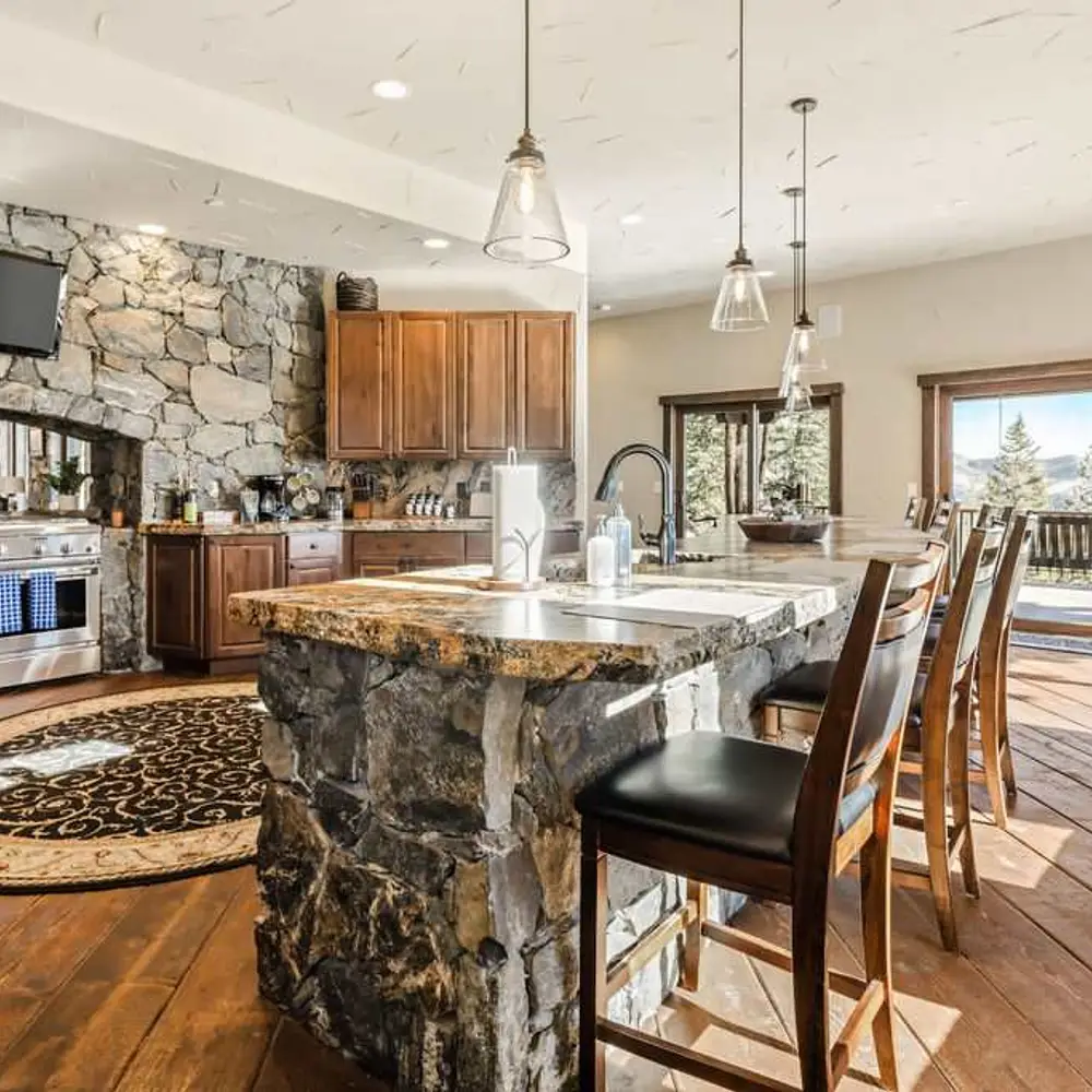 Luxe open kitchen with high-end stainless steel appliances and island bar-style seating