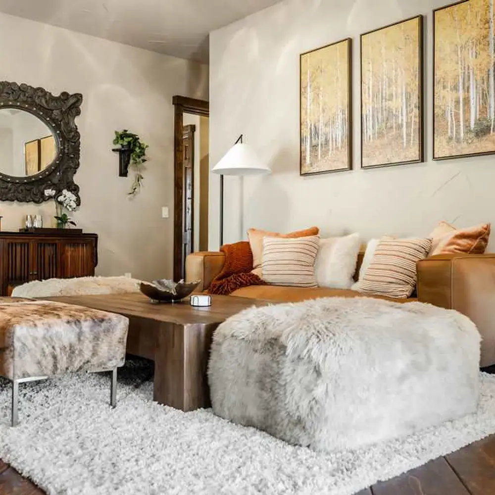 Second-level living area with a gas fireplace, flatscreen TV, and balcony exit
