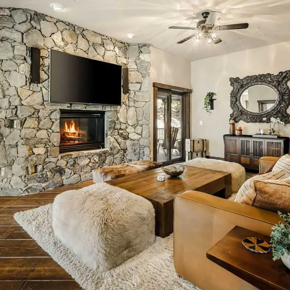 Second-level living area with a gas fireplace, flatscreen TV, and balcony exit