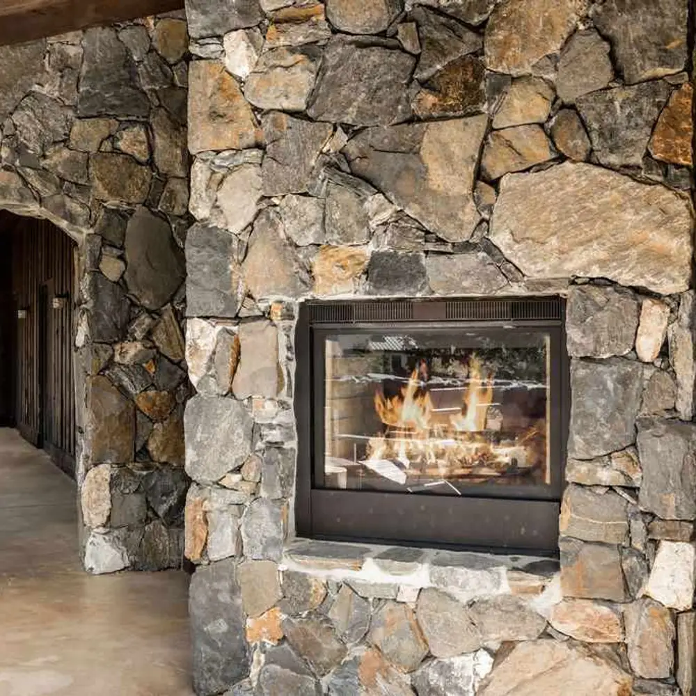 Second-level deck with seating and a see-through fireplace