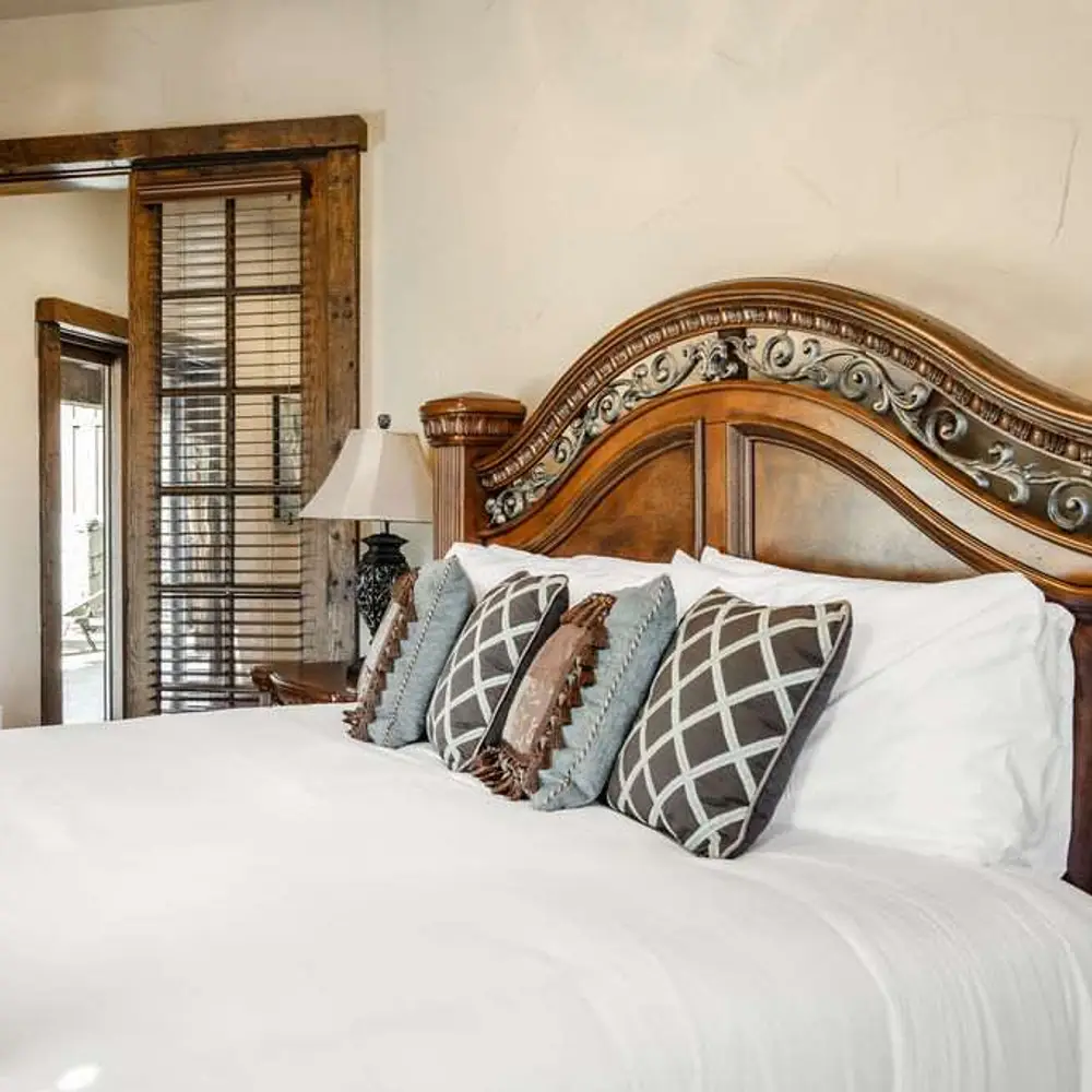 Bedroom 4 with a king bed, a flatscreen TV, a see-through gas fireplace, a balcony exit, and a private full ensuite bathroom
