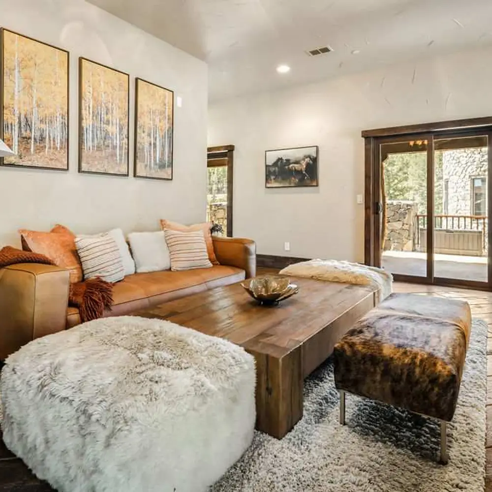 Second-level living area with a gas fireplace, flatscreen TV, and balcony exit
