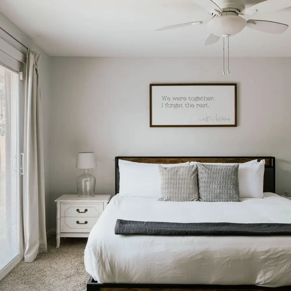 Bedroom 1 has king bed, ceiling fan, and sliding doors to backyard