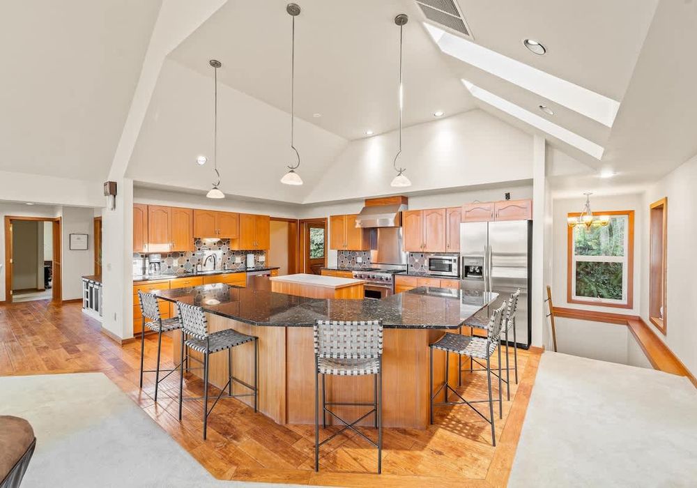 Large, gourmet kitchen with island and breakfast bar seating.
