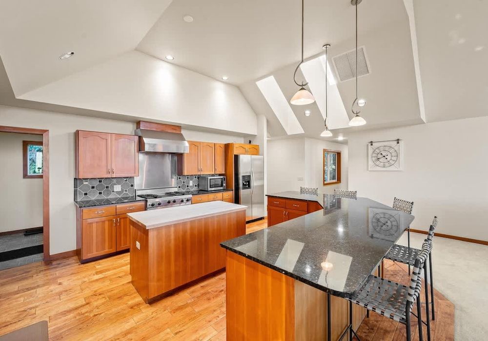 Large, gourmet kitchen with island and breakfast bar seating.