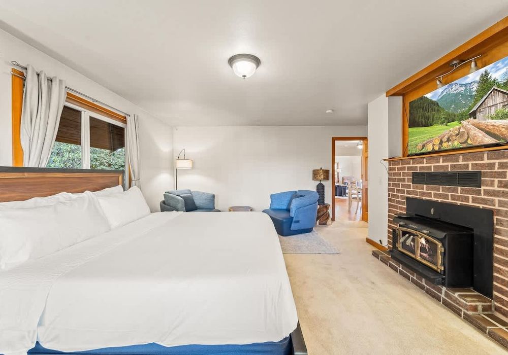 Primary bedroom on main level, with King bed, fireplace and walkthrough bathroom.