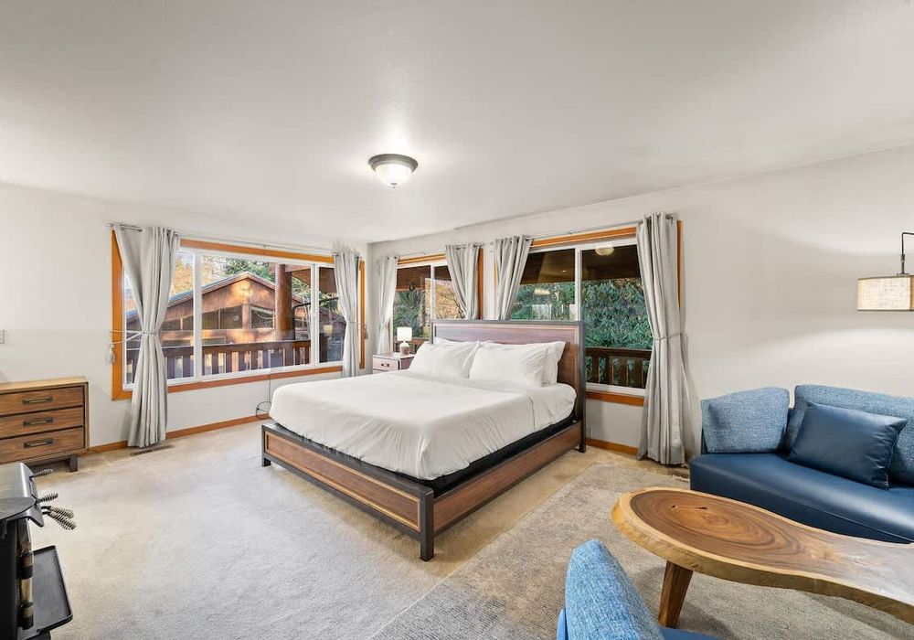 Primary bedroom on main level, with King bed, fireplace and walkthrough bathroom.