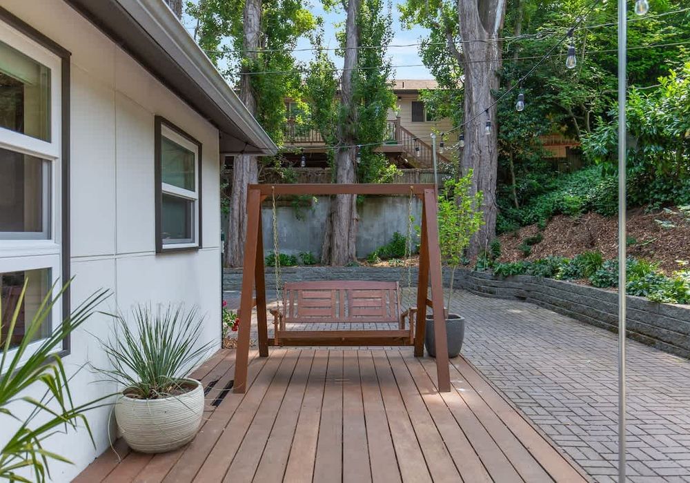 Welcome to your cozy nook: our porch swing, where simple pleasures meet tranquil moments.