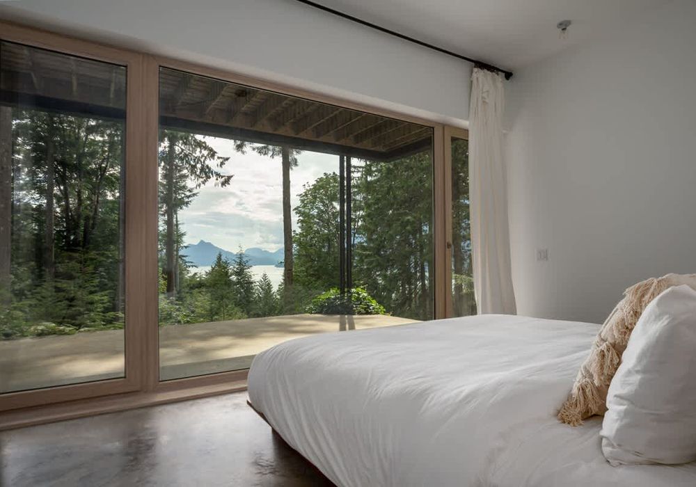 The primary suite with floor to ceiling windows and incredible views.