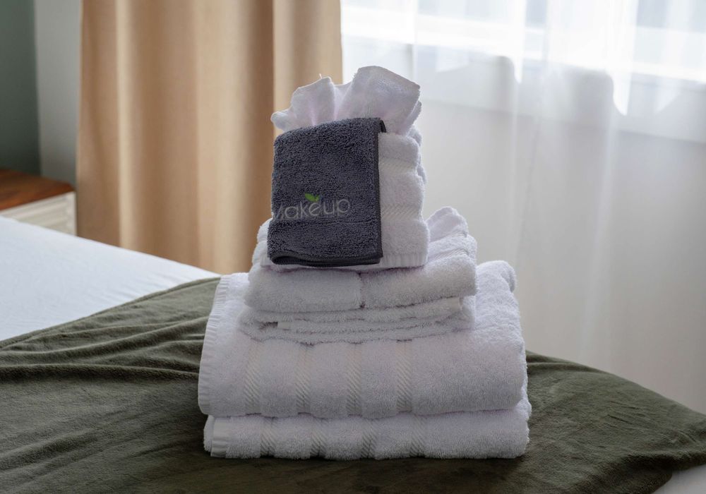 Every bed is made with care—plush towels and linens ready for your stay.