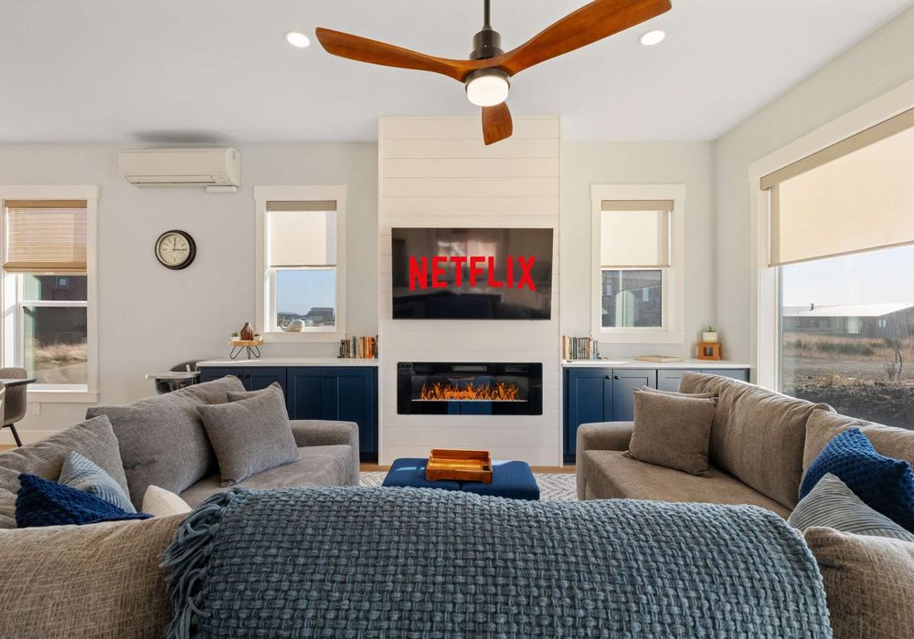 Unwind on plush sofas, stream your favorite shows, and enjoy the warmth of the electric fireplace after a day at the beach.