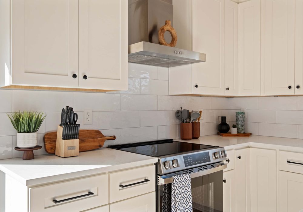 Fully stocked kitchen with coffee gear, pots, pans, and quality appliances.