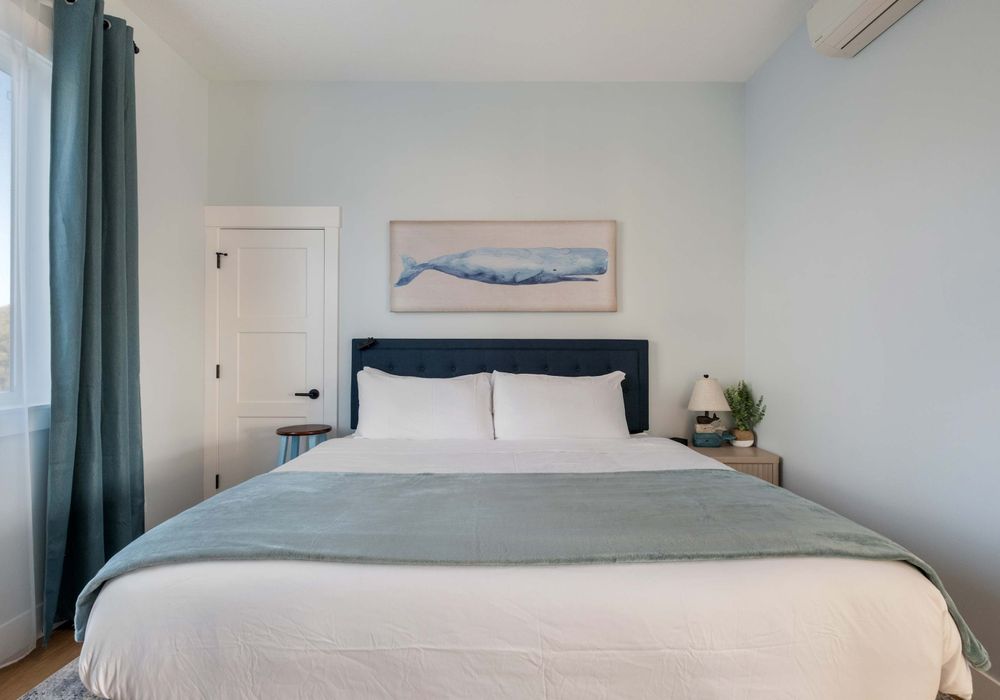 Bright and relaxing king bedroom—simple and peaceful with easy access.