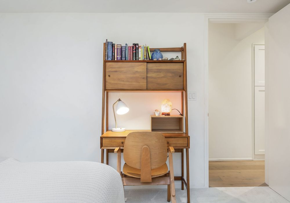 Balance work and relaxation at your functional laptop station in the cozy space.