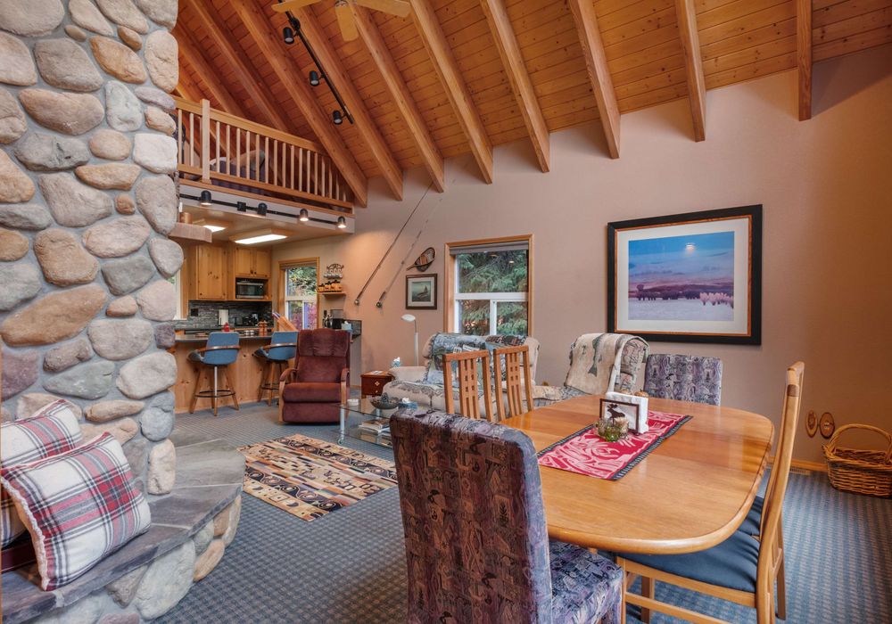 The dining room boasts a spacious table and a warm, inviting setting, perfect for relaxed meals.