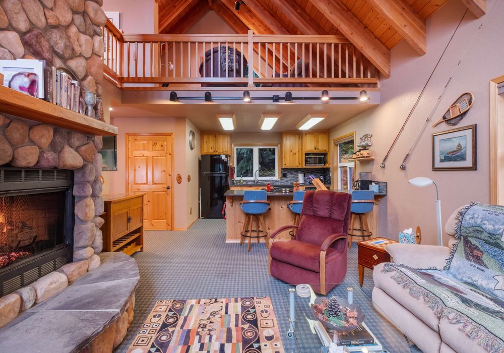 With a firepit as the centerpiece, this living room offers a warm, inviting space for relaxation and conversation.