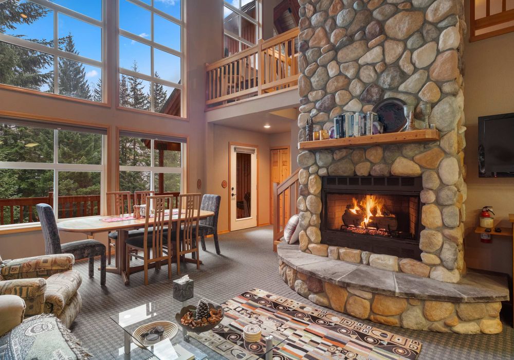 The open layout features a welcoming living room, a stylish dining room, and a gorgeous firepit that adds warmth and charm.