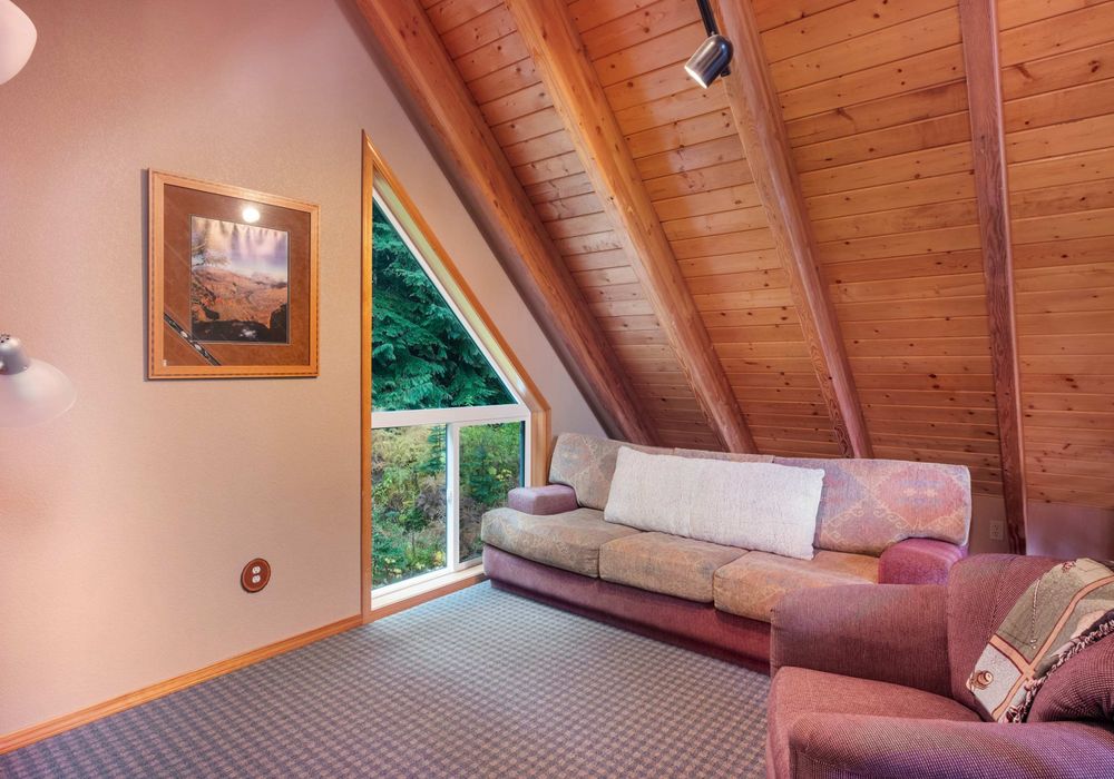Unwind on the playful pink sofa while taking in the calming green views outside—your perfect retreat.