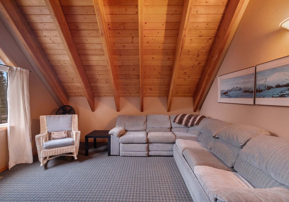 Extra seating in the loft offers the ideal spot to unwind, complemented by a soothing scenic view.