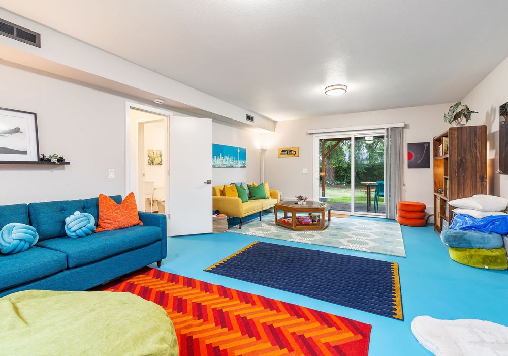 Step into our dynamic room, where vibrant carpets and a plush sofa bring color and comfort together!