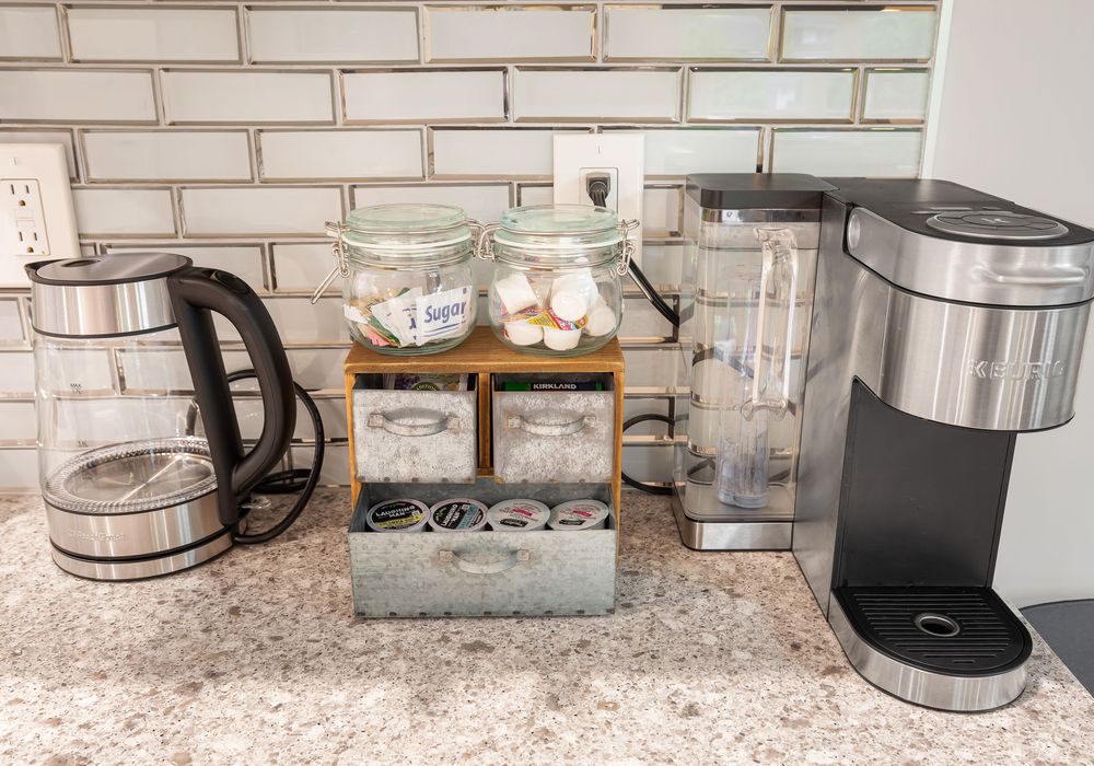 The kitchen features a Keurig coffee maker, complete with coffee, sugar, and cream to help you start your day with ease.