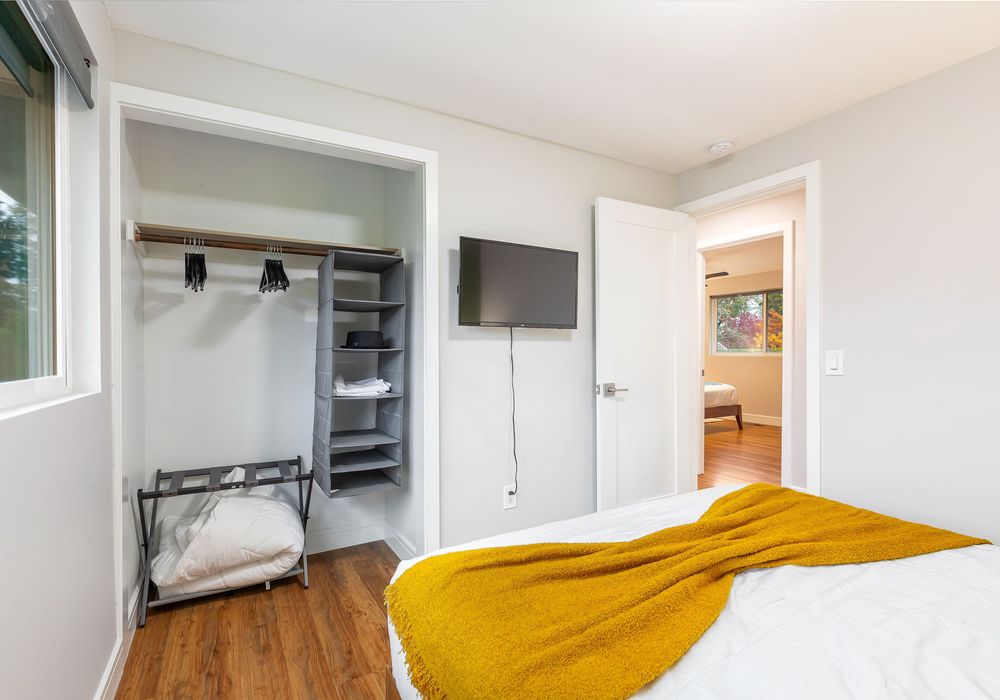 This inviting bedroom offers a roomy closet and a wall-mounted TV for the ultimate in comfort and convenience.