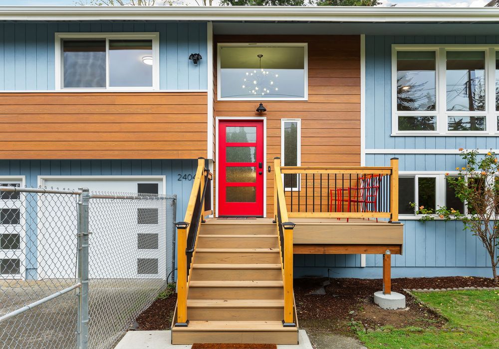 Welcome to Seattle! The vibrant red door leads the way, offering a cheerful entrance to this charming home.