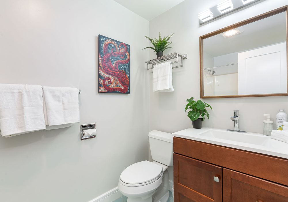 The bathroom is designed with modern fixtures and plenty of space.