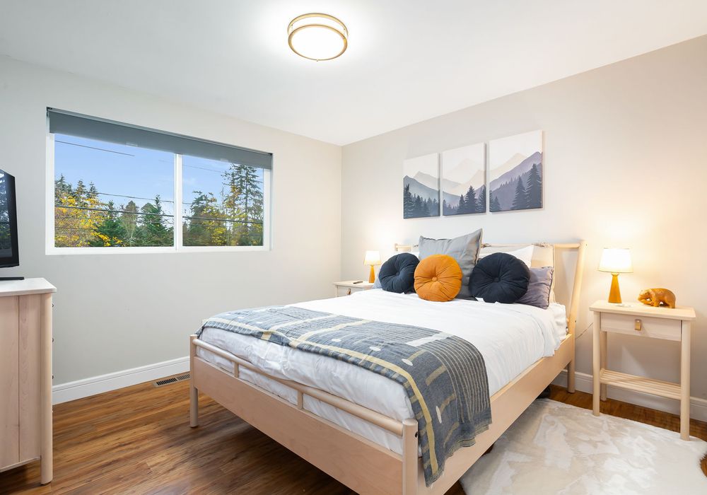 Bedroom with a window that not only adds to the room’s brightness but also offers scenic views of the outdoors.