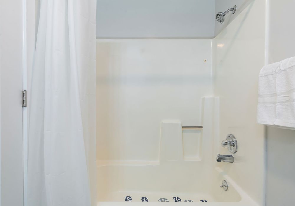 The bathroom is designed with modern fixtures and plenty of space.