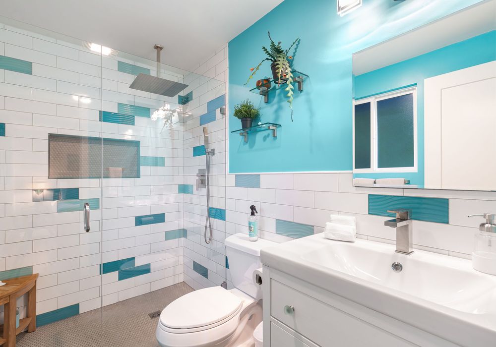 With its cool blue tones and contemporary design, this bathroom blends modern elegance with calming vibes.