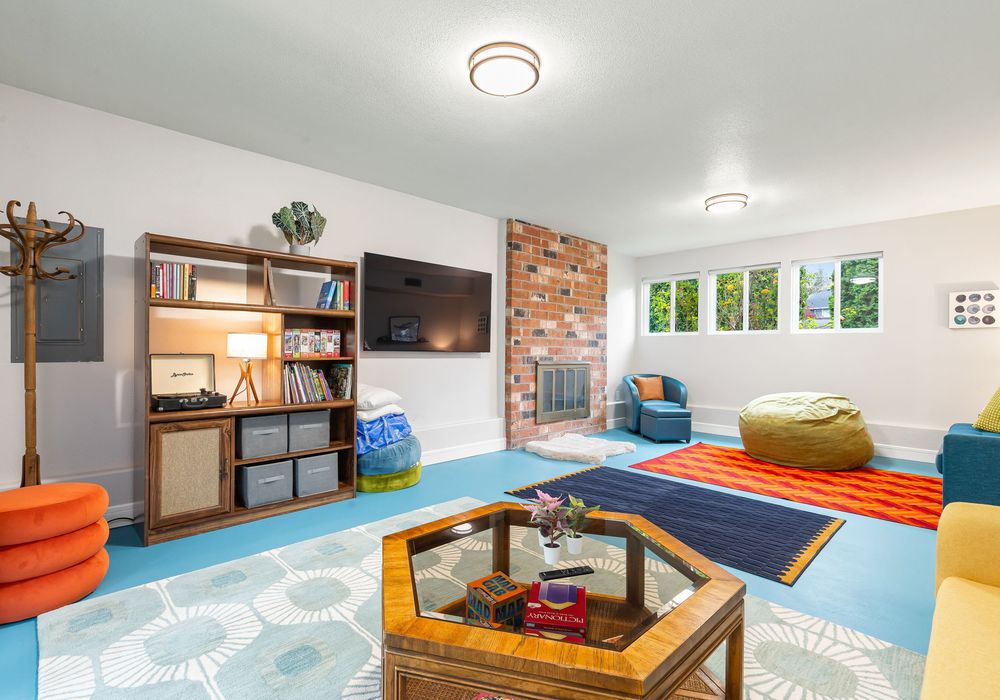 A perfect spot with fireplace for unwinding, offering a collection of games, a TV for movie nights, and shelves filled with books.