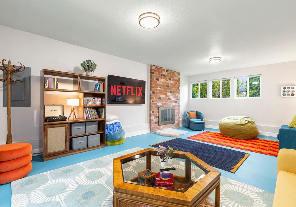 A perfect spot with a fireplace for unwinding, plus a collection of games, a TV for movie nights, and shelves filled with books.