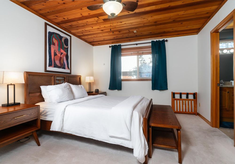 Primary bedroom: Queen bed with windows on both sides.