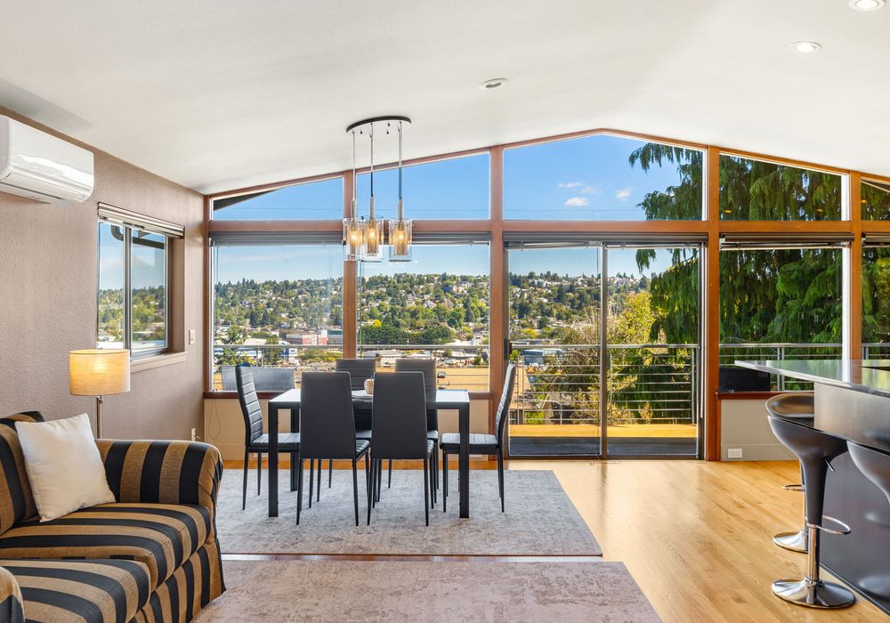 Light-filled living space with large windows and a cozy atmosphere.