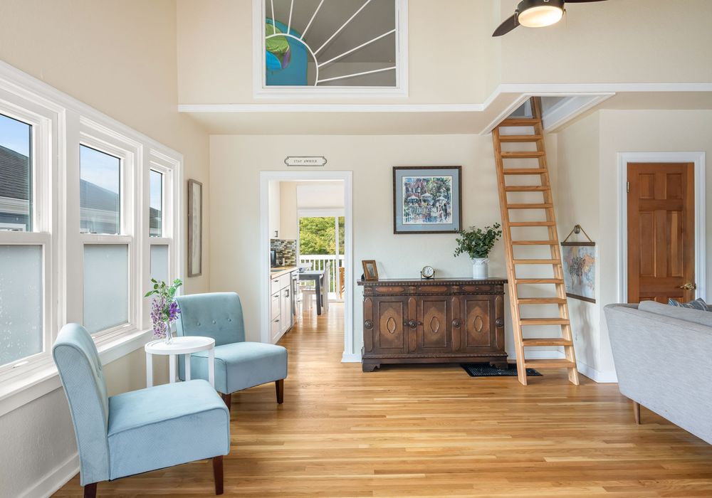 Spacious lounge with open flow to dining and deck + ladder to the kids loft / play area.
