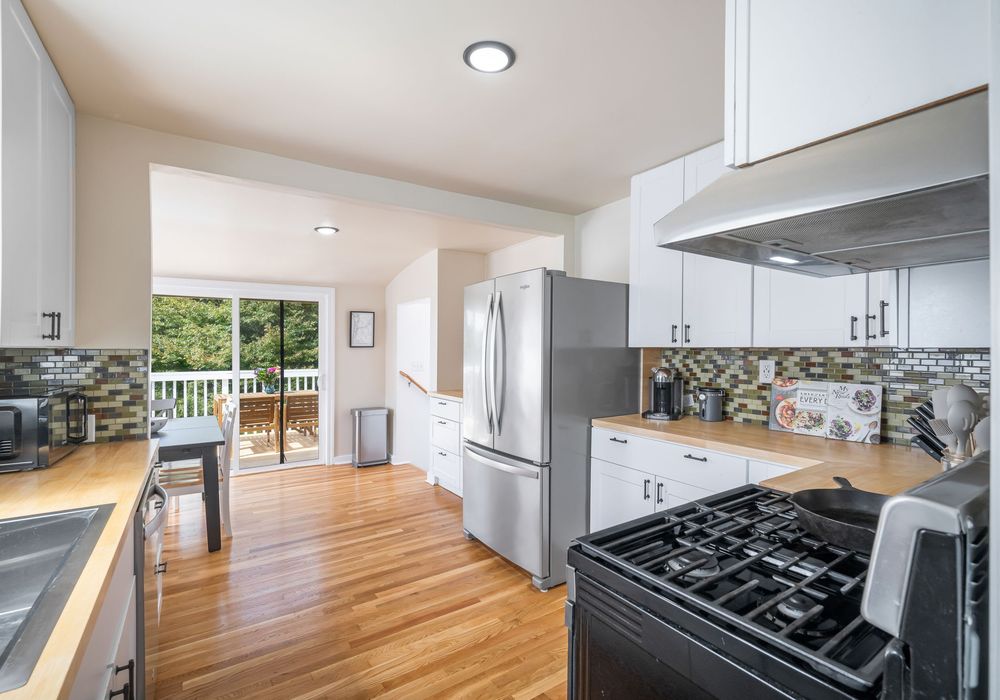 Bright kitchen with easy deck access for indoor-outdoor dining.