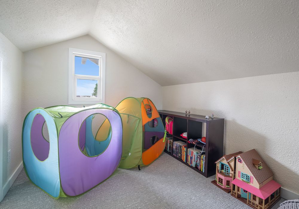 Kids’ loft playroom — books, toys, and space to explore.
