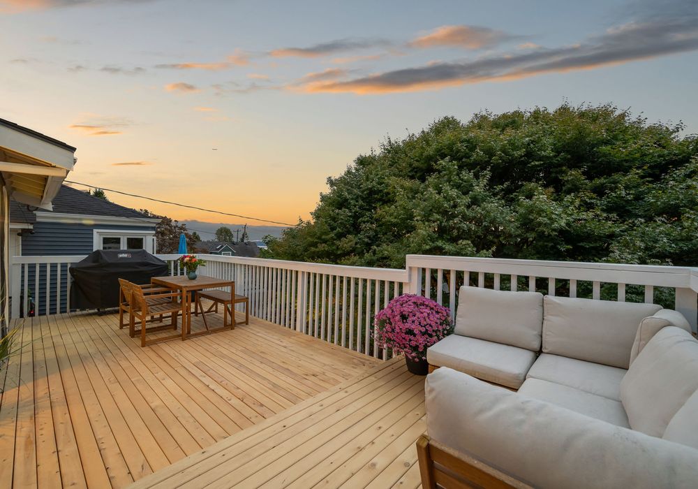 Upper deck with outdoor sofa and sunset views — the perfect place for wine and conversation.