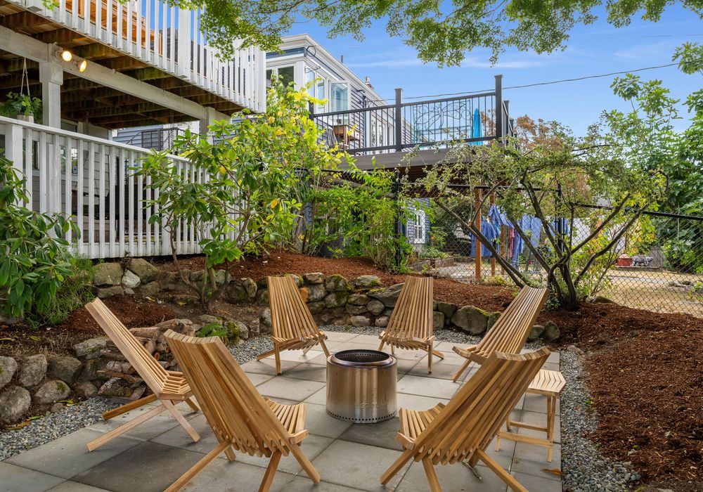 Backyard fire pit with Adirondack seating — gather for s’mores and stories under the stars.