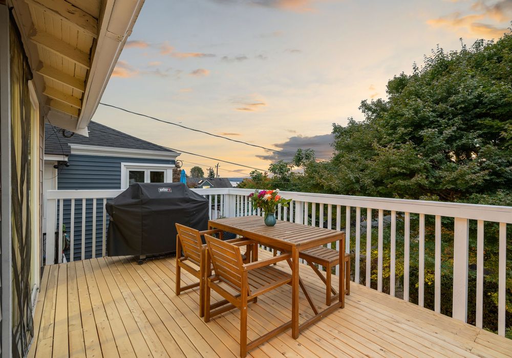 Upper deck with outdoor sofa and sunset views — the perfect place for wine and conversation.
