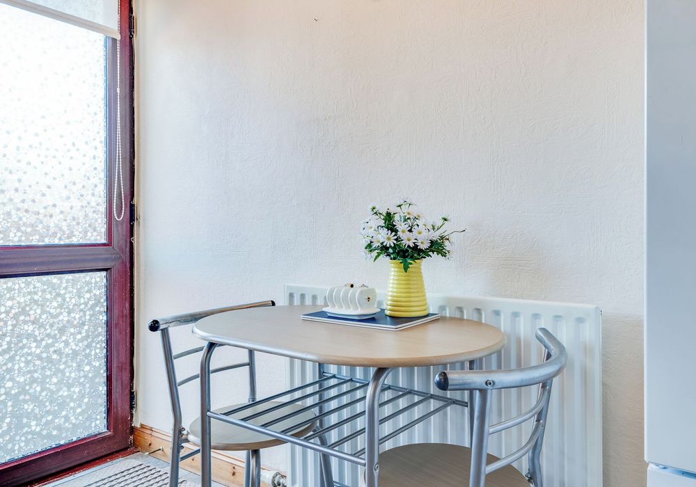 Enjoy casual meals or morning coffee in this sunny, inviting corner.