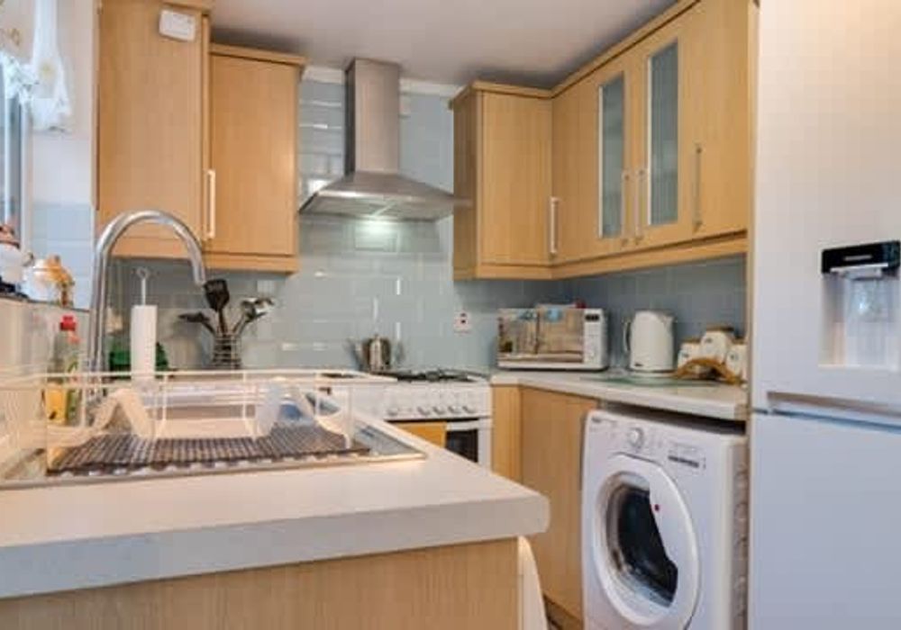 A fully equipped kitchen - including a washing machine.
