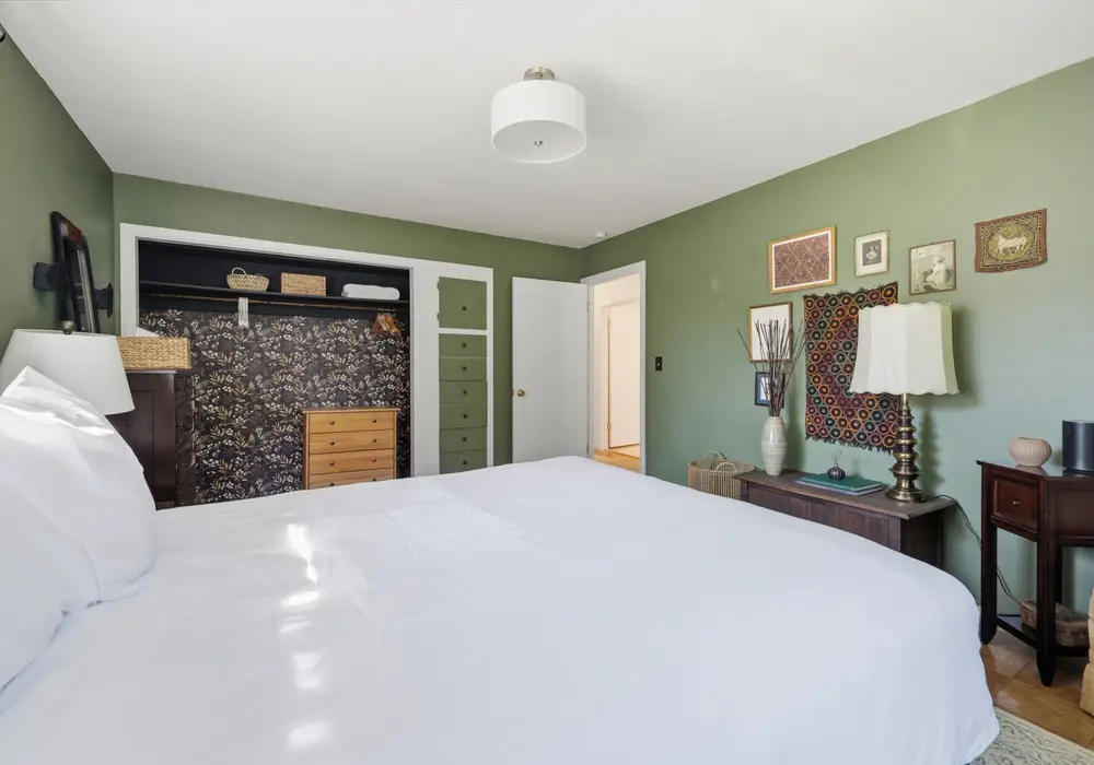 Bright and inviting queen bedroom with cozy touches throughout.