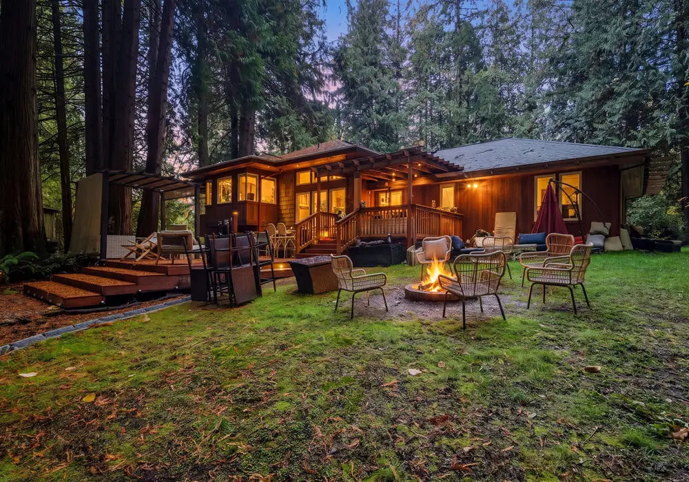 Unwind outdoors and take in the quiet beauty of the property, beautifully lit as evening settles in.