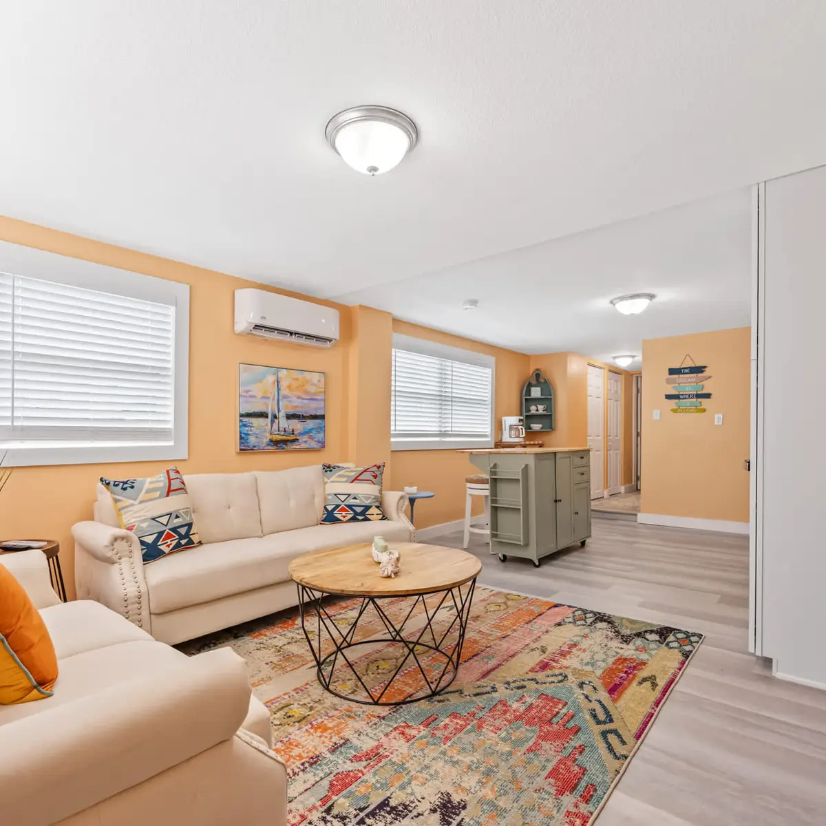 Cozy living area with soft seating and colorful accents for relaxing gatherings.