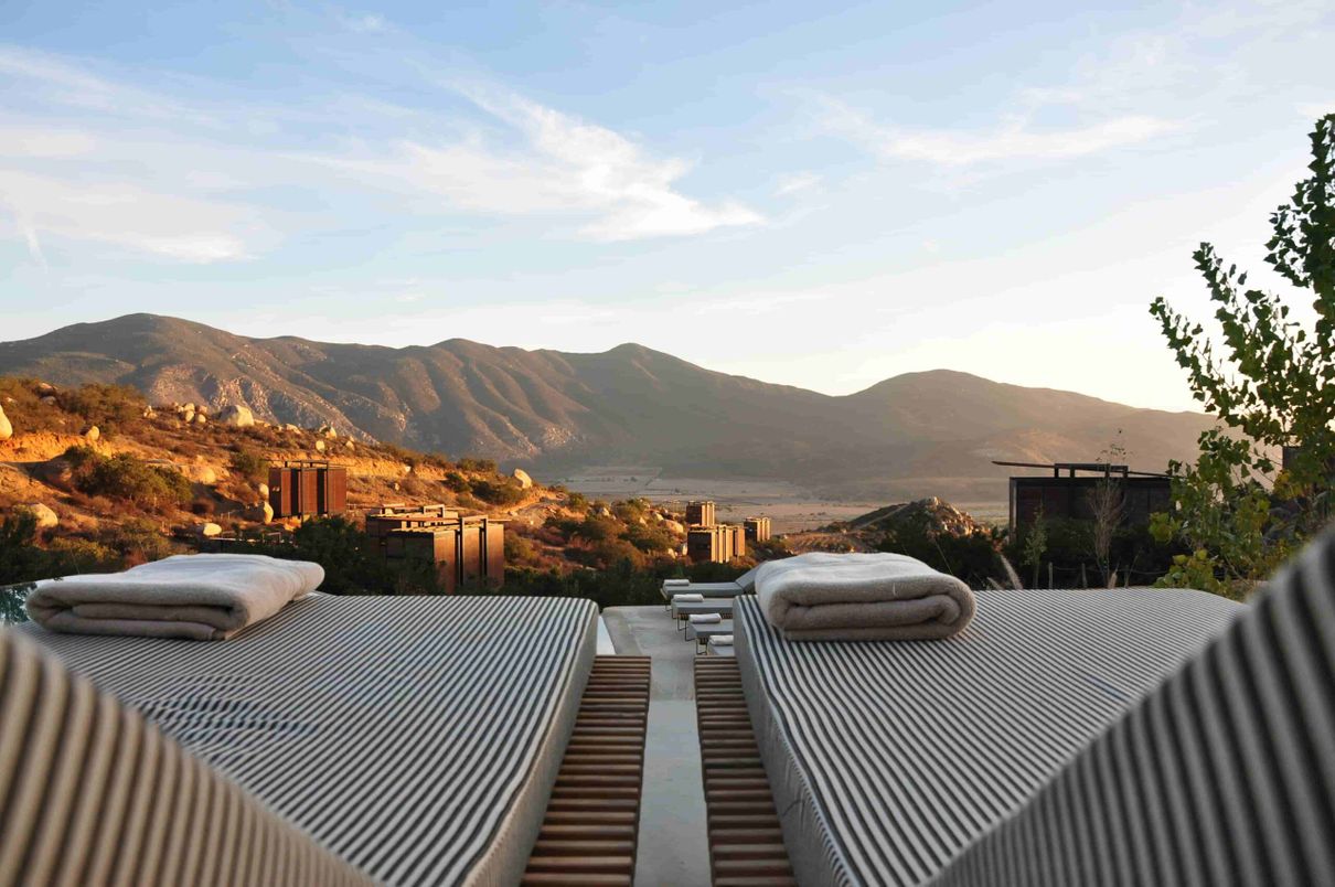 a group of beds with a view of mountains in the background